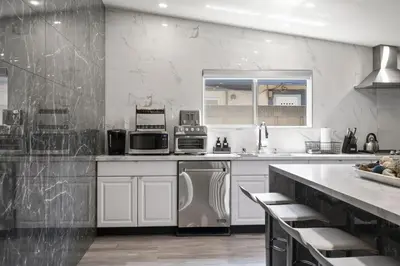 a kitchen with white appliances and a counter top at Galactic Getaway Close to Disney with Pool and Games in Anaheim