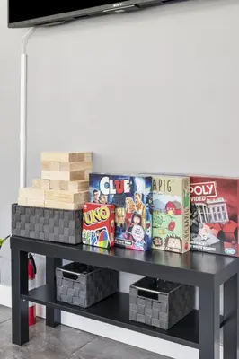 a black table with snacks and books on it at Galactic Getaway Close to Disney with Pool and Games in Anaheim