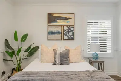 a bedroom with a bed with pillows and a window at Refreshing Escape- Hot Tub- Games- Sleeps 10 in Long Beach