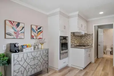 a kitchen with white walls and a counter top at Aqua Oasis - Games - Close to DT - Sleeps 10 in Montebello