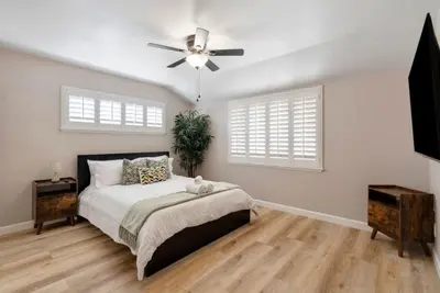 a bedroom with a bed and a ceiling fan at Aqua Oasis - Games - Close to DT - Sleeps 10 in Montebello