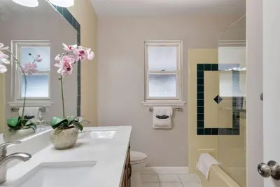 a bathroom with a sink and a toilet and a shower at Aqua Oasis - Games - Close to DT - Sleeps 10 in Montebello