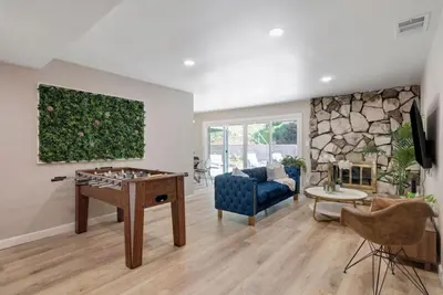 a living room with a couch and a table at Aqua Oasis - Games - Close to DT - Sleeps 10 in Montebello