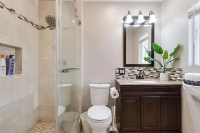 a bathroom with a toilet and a sink and a shower at Aqua Oasis - Games - Close to DT - Sleeps 10 in Montebello