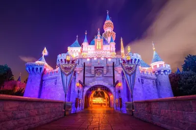 a castle is lit up in purple at night at Trendy Getaway - Hot Tub - Putt Putt - Games in Long Beach