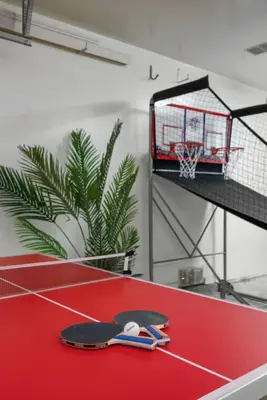 a basketball hoop with a basket on a red court at Trendy Getaway - Hot Tub - Putt Putt - Games in Long Beach