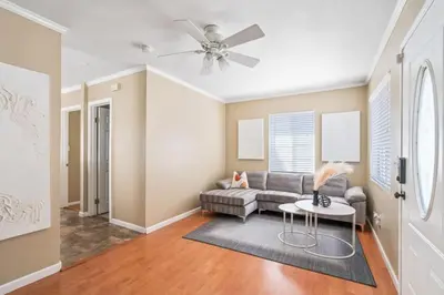 a living room with a couch and a ceiling fan at Serene Yard Porch at Signal Hill - Close to the Beach in Signal Hill
