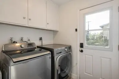 a kitchen with a washing machine and a window at 2-Story Sanctuary - Spacious Hot Tub - Billiards in Los Angeles