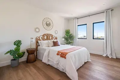 a white bedroom with a bed and a large window at ArtsDistrictDtLA-2022 BUILT WithVIEWS WD - GARAGE in Los Angeles