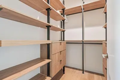 a walk in closet with wooden shelving and shelves at ArtsDistrictDtLA-2022 BUILT WithVIEWS WD - GARAGE in Los Angeles