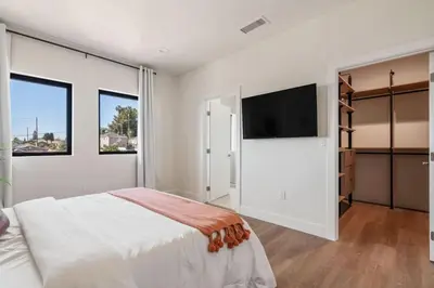 a bedroom with a large bed and a flat screen tv at ArtsDistrictDtLA-2022 BUILT WithVIEWS WD - GARAGE in Los Angeles
