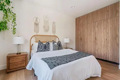 a bedroom with a large bed and two lamps at ArtsDistrictDtLA-2022 BUILT WithVIEWS WD - GARAGE in Los Angeles