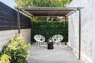 a patio with two white chairs and awning at Iconic LACasita -FoodieBobaliciousCity- Mins2DTLA in Alhambra