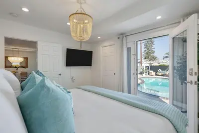 a bedroom with a bed and a tv and a pool at Coastal Lagoon - Pool Heating - Games - Air Hockey in Long Beach