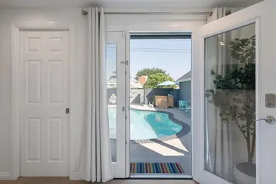 an open door with a view of a swimming pool at Coastal Lagoon - Pool Heating - Games - Air Hockey in Long Beach