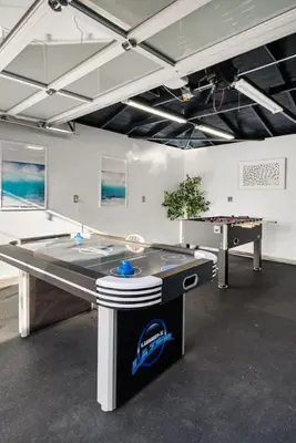 a ping pong table in a room with a pool table at Coastal Lagoon - Pool Heating - Games - Air Hockey in Long Beach