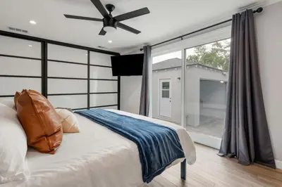 a bedroom with a bed and a large window at Luxury Hangout - Private Spa - Game Room - Arcade in Long Beach