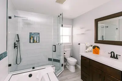 a bathroom with a shower and a toilet and a sink at Luxury Hangout - Private Spa - Game Room - Arcade in Long Beach