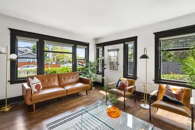 a living room with a couch and chairs and windows at HGTV Featured Modern Craftsman Mins2Beach GameRm in Long Beach