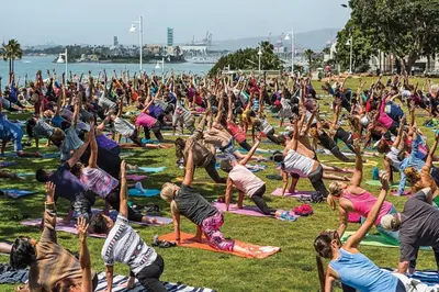 a large group of people doing yoga in the grass at HGTV Featured Modern Craftsman Mins2Beach GameRm in Long Beach