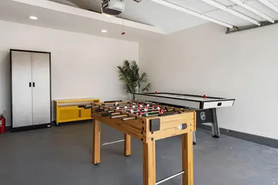 a ping pong table in a room with a pool table at HGTV Featured Modern Craftsman Mins2Beach GameRm in Long Beach