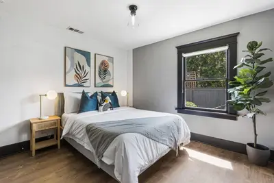 a bedroom with a large bed and a window at HGTV Featured Modern Craftsman Mins2Beach GameRm in Long Beach