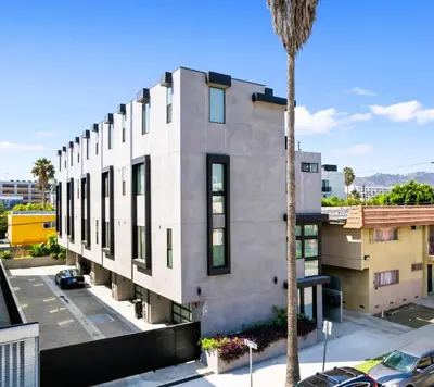 a building with a palm tree in front of it at Trendy Chic in Los Angeles