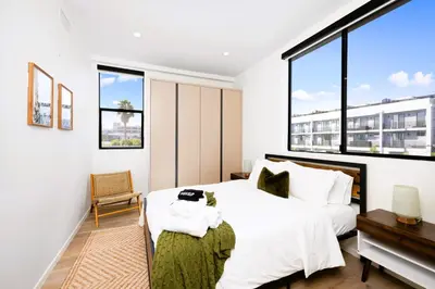 a bedroom with a bed and a large window at Trendy Chic in Los Angeles