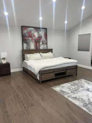 a bedroom with a bed and a painting on the wall at Woodland Hills 1 Bedroom Getaway in Woodland Hills