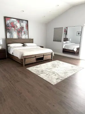 a bedroom with a large bed and two mirrors at Woodland Hills 1 Bedroom Getaway in Woodland Hills