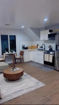 a kitchen with white cabinets and a table in it at Woodland Hills 1 Bedroom Getaway in Woodland Hills