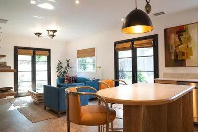 a living room with a table and chairs at Spanish-style garden Bungalow in Burbank