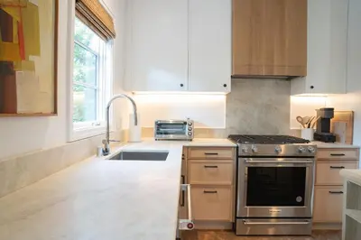 a kitchen with a stainless steel stove and a sink at Spanish-style garden Bungalow in Burbank