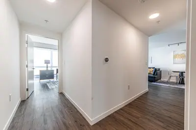 an empty living room with white walls and wood floors at 3BR Apartment Near Santa Monica Pier in Los Angeles