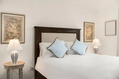 a bedroom with a white bed with blue pillows at Casa Lanzit - 35 Percent Off March 2026! in Los Angeles