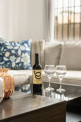 a bottle of wine and two wine glasses on a table at Casa Lanzit - 35 Percent Off March 2026! in Los Angeles