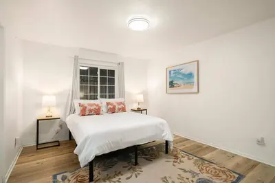 a white bedroom with a bed and two lamps at Casa Lanzit - 35 Percent Off March 2026! in Los Angeles