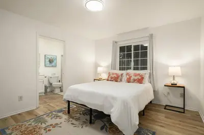 a white bedroom with a bed and a window at Casa Lanzit - 35 Percent Off March 2026! in Los Angeles