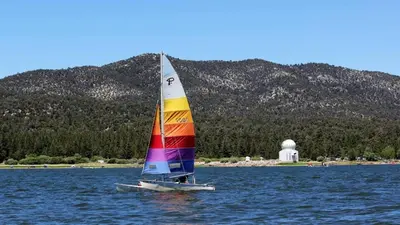 a sail boat in the middle of the water at The Train Getaway Big Bear Lake in Big Bear Lake