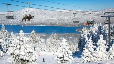 a group of people riding a ski lift in the snow at Summit Ski Shack in Big Bear Lake