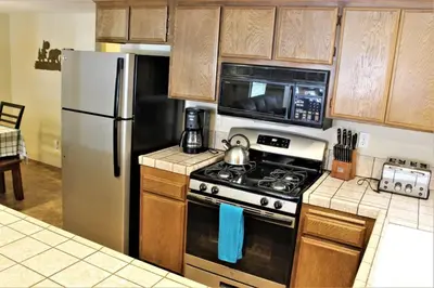 a kitchen with a stove and a refrigerator at Summit Ski Shack in Big Bear Lake
