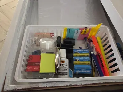 a drawer filled with office supplies and other office items at Minimalist Lake House in Helendale