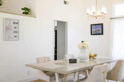 a white dining room with a white table and chairs at Luxe Spacious Home Near Parks Fully Equipped in Riverside