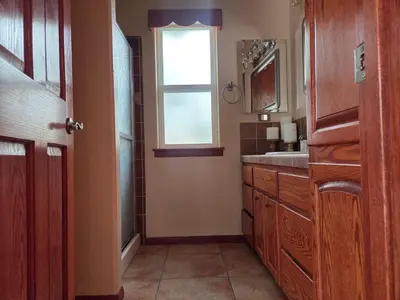 a bathroom with a sink and a window at Zen Den Studio in Apple Valley