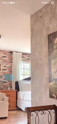 a bedroom with a bed and a brick wall at Zen Den Studio in Apple Valley