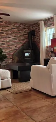 a living room with a couch and a fireplace at Zen Den Studio in Apple Valley