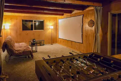 a room with a board and a large pool table at Stunning Deck Views Cozy Running Springs Cabin in Running Springs