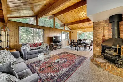 a living room with a couch and a fireplace at Stunning Deck Views Cozy Running Springs Cabin in Running Springs