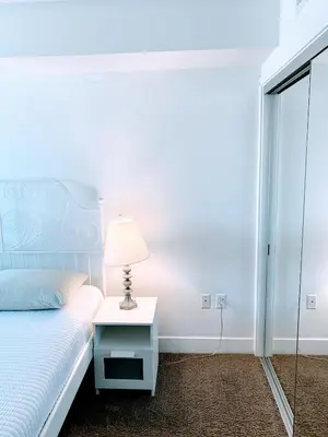 a bedroom with a bed and a lamp on a table at Western Melrose in Los Angeles