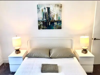 a bedroom with a white bed with two lamps at Western Lemon Grove in Los Angeles